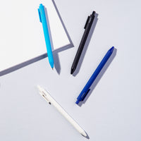 The PK Cool Vivid Gel Pens and a notebook displayed on a grey background.