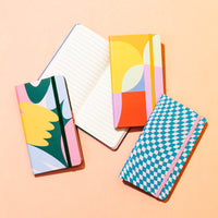 Pattern Hardcover Notebooks on a peach background.
