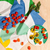 Bamboo Salad Plates in Flora with food on it on a cream background.