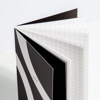A close-up image of an opened Folio Notebook on a white background. 