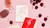 Poketo Greeting cards on a pink background with cherries spread around. 