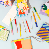 The Pocket Notepads amongst other Poketo Stationary on a blue background.