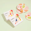 Set of 4 Poketo Bamboo Coasters in Chips and packaging in a white background. 