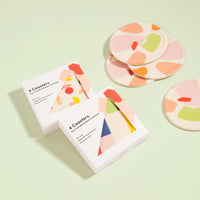 Set of 4 Poketo Bamboo Coasters in Chips and packaging in a white background. 