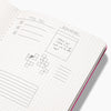 Inside the Everyday Notebook in Dotted with writing on a white background. 