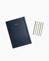 The Midnight Project Planner and Prism Roller ball pen set on a white background. 