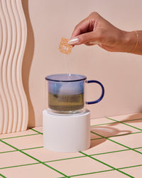 Double Wall Mug Blue with a tea bag in it