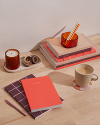 Concept Planner in Tangerine in a desk setting.