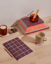 Object Notebook in Maroon in a desk background. 
