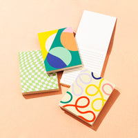 The Pocket Notepads on a beige background. 
