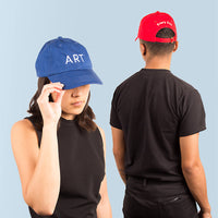 Art Every Day Caps in Cobalt and Red worn showing the front and back views.