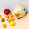 Bamboo serving bowl in Pebbles with spilled fruit