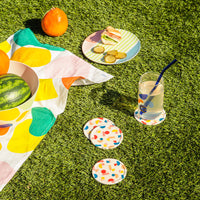 Poketo coasters in Chips; featuring our tea towel in stripes and boulders, salad plate in Angles drinking glass in Aqua and glass straws in Cool